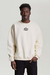 Model wearing beige NV Loose Sweatshirt with black logo