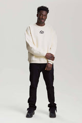 Full-body view of model wearing beige NV Loose Sweatshirt with black logo