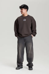 Model wearing gray NV Loose Sweatshirt with white logo