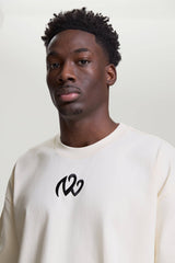 Close-up of beige NV Loose T-Shirt with black logo by TURN ENVY TO LOVE