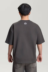 Back view of gray NV Loose T-Shirt with small white logo below the neckline – urban streetwear by TURN ENVY TO LOVE
