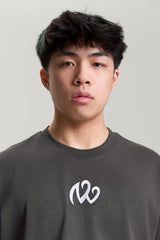 Close-up of NV Loose T-Shirt in gray with embroidered white logo – premium streetwear by TURN ENVY TO LOVE