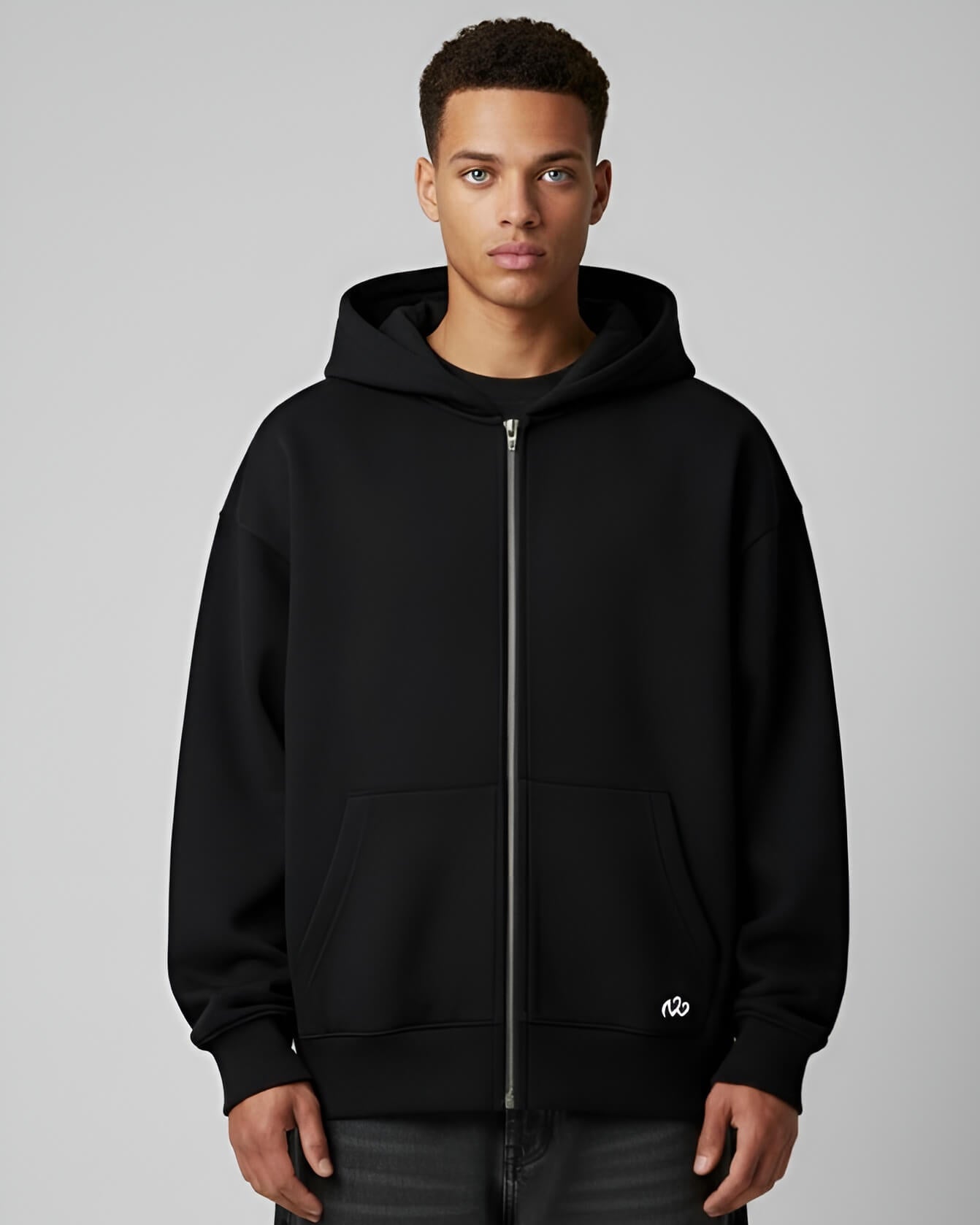 Male model front view in black zip hoodie with white logo and silver zipper